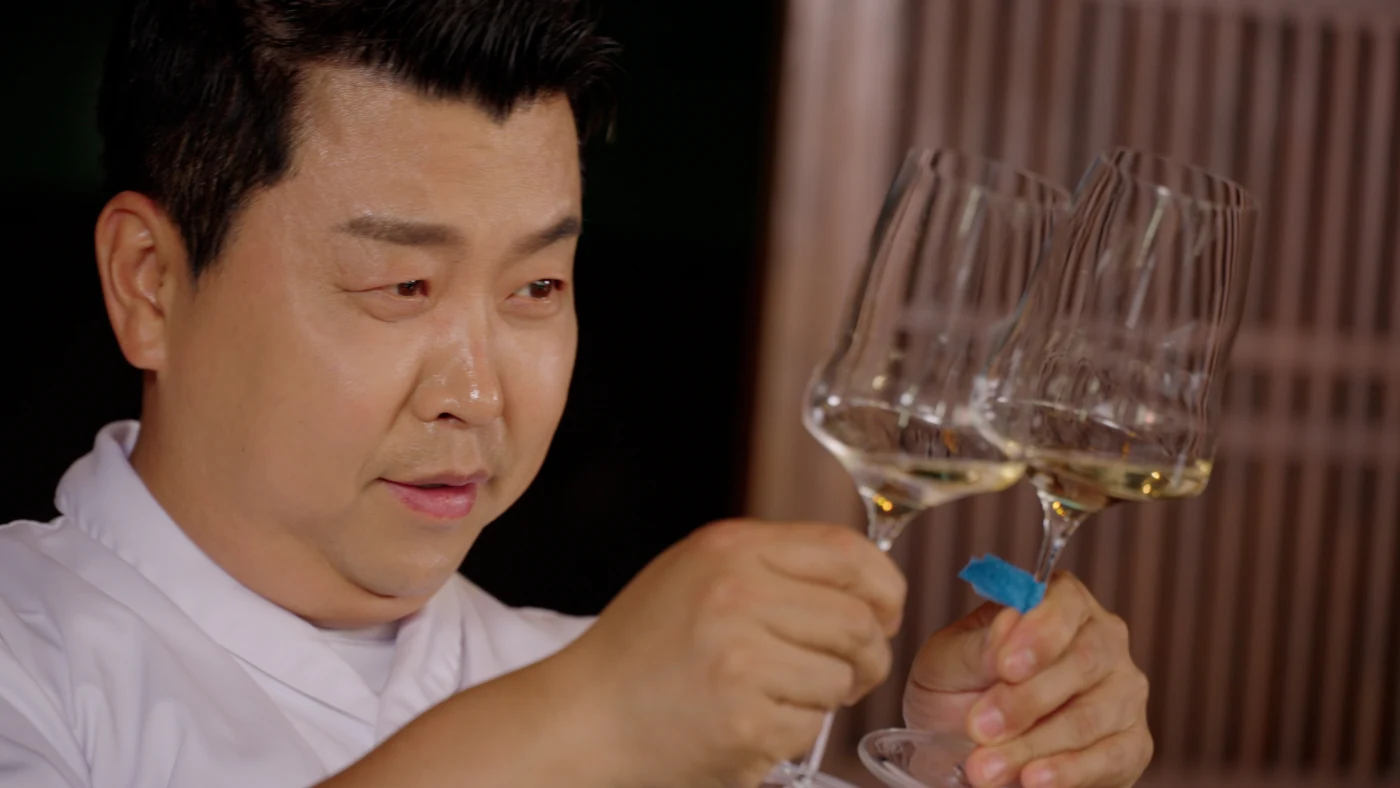 와인 잔을 바라보는 정호영 셰프
